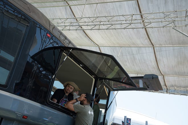 People gather around a model of the Lightship L1 electric travel trailer at the Electrify Expo outside State Farm Stadium on May 4, 2024 in Glendale, Ariz.