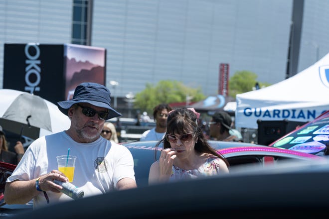 David (left) and Lynette Carrington look at the customized electric vehicles display at the Electrify Expo outside State Farm Stadium on May 4, 2024 in Glendale, Ariz.