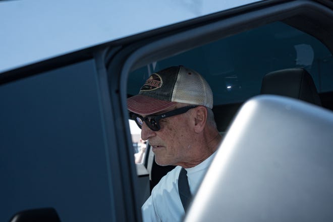 Michael Carneal takes a look inside the Tesla Cybertruck at the Electrify Expo outside State Farm Stadium on May 4, 2024 in Glendale, Ariz. Michael has been on a waiting list for a different model of the Cybertruck for multiple years.