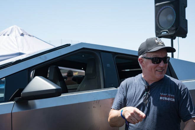 Jeff Blake takes a look at the Tesla Cybertruck on display at the Electrify Expo outside State Farm Stadium on May 4, 2024 in Glendale, Ariz.