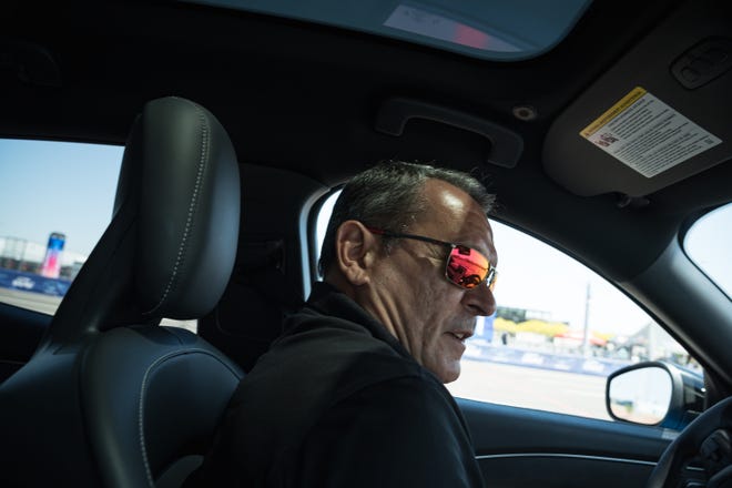 Professional driver, Andre Serra drives in one of Fordâ€™s â€œHot Lapsâ€ at the Electrify Expo outside State Farm Stadium on May 4, 2024 in Glendale, Ariz. Serra drives a Mustang Mach-E all electric SUV in a short stunt driving course.