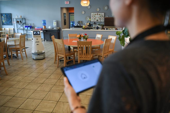 Owner Kultida Blais uses a tablet to control Fai Thai's new Plato server robot at the restaurant in Knoxville, Thursday, May 23, 2024.