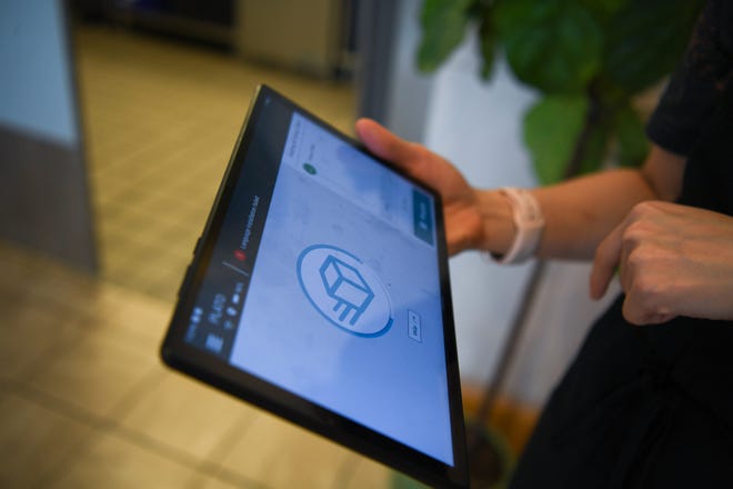 Owner Kultida Blais uses a tablet to control Fai Thai's new Plato server robot at the restaurant in Knoxville, Thursday, May 23, 2024.