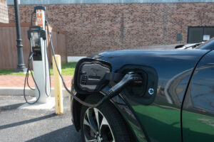 An electric vehicle juices up at a charging station.