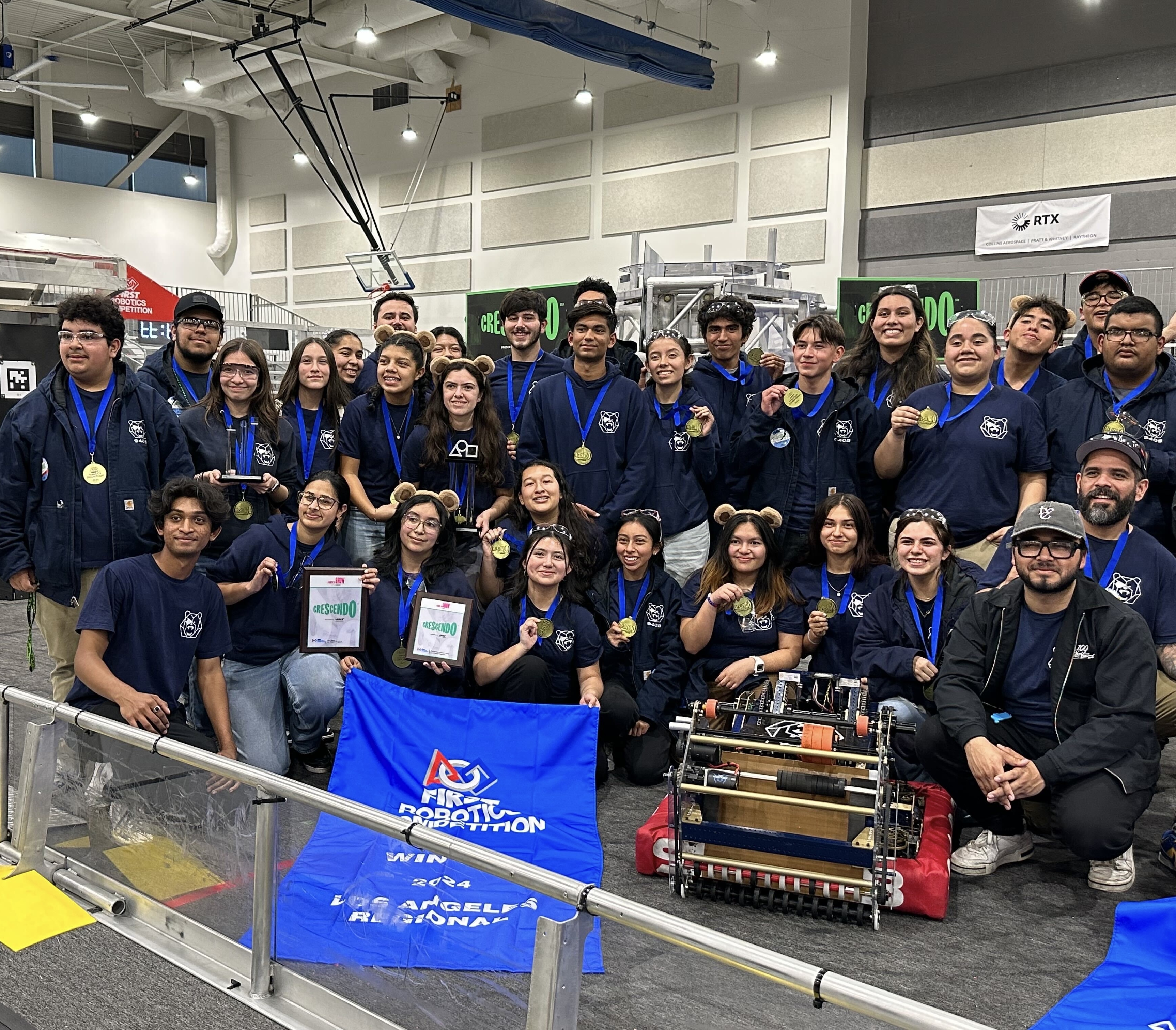 Warren High's Warbots pose with their Winners banner at the 2024 FIRST Robotics Los Angeles Regional robotics competition.