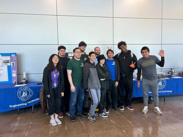 All robotics students that had an invention in the Robotics Exhibition pose for the camera after the winners had been chosen. (Tommy Kallman | The Union)