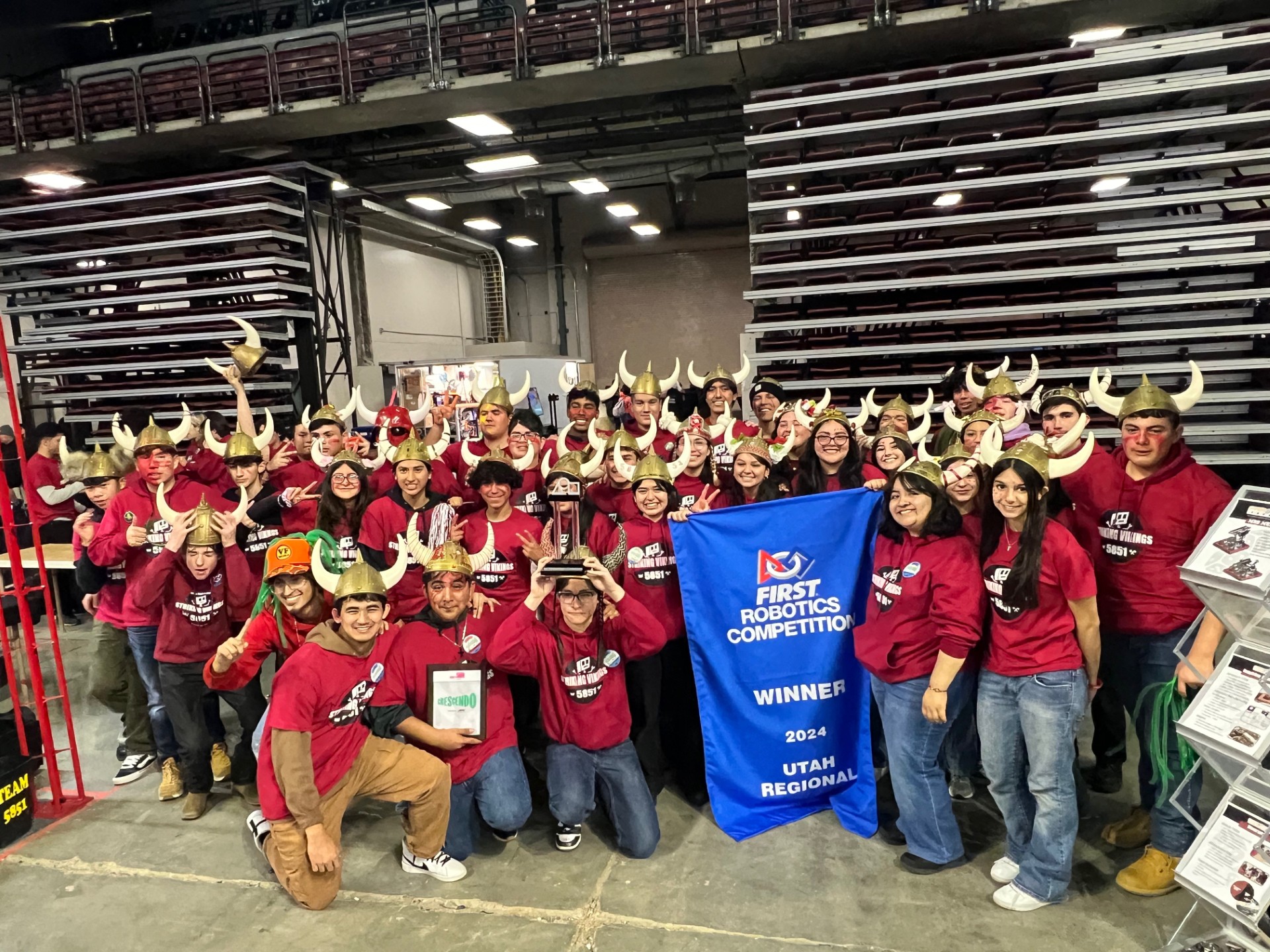 Downey High's Striking Vikings pose with their Winners banner at the 2024 FIRST Robotics Utah Regional robotics competition.