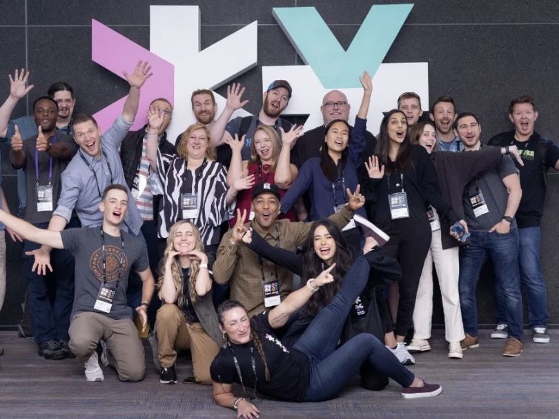  The Moov team poses with arms outstretched for a group photo.