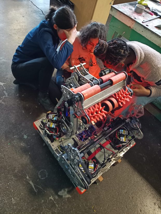 Members of Woodland's Team 5458: Digital Minds tending to their robot, which won prestigious awards during both of the FIRST Robotics regional competitions they participated in April. (Courtesy)