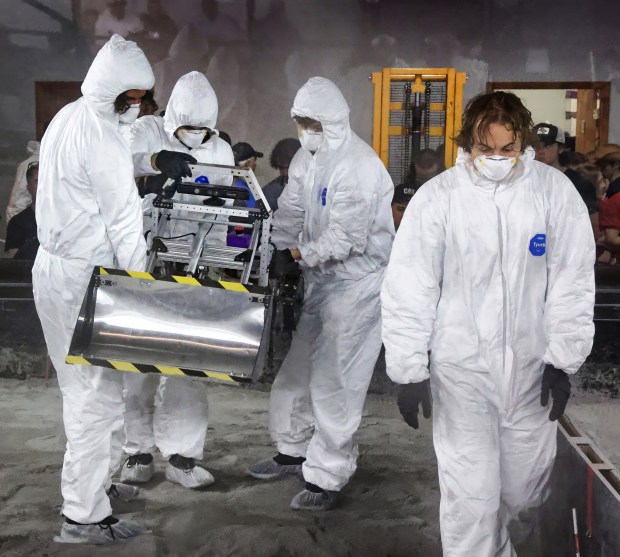 Members of the University of Central Florida's robotics team carry their entry out of the competition court after it failed to start in the national NASA Lunabotics Challenge, at the UCF Exolith Lab, Tuesday, May 14, 2024. (Joe Burbank/Orlando Sentinel)