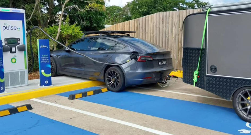 An EV towing a trailer which does not fit in an ordinary charging bay