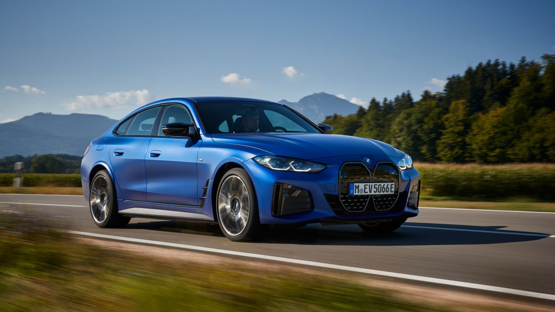 Blue 2023 BMW i4 M50 Driving