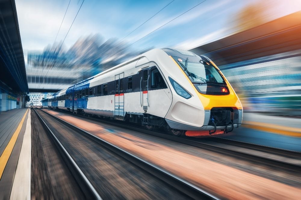 A high speed train in motion with the blurred railway stating visible in the background in piece about the future of large language models.