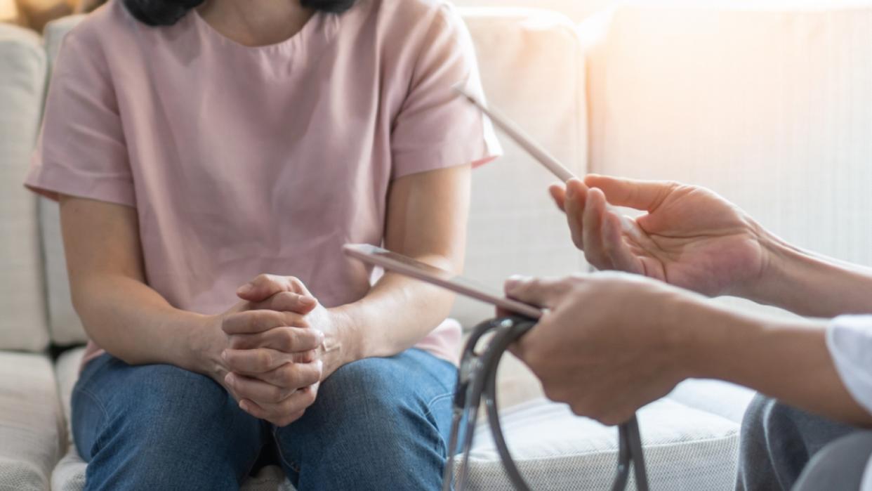 Woman patient consulting with doctor.