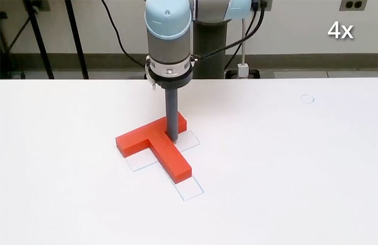 UR5 cobot push a "T" around a table.