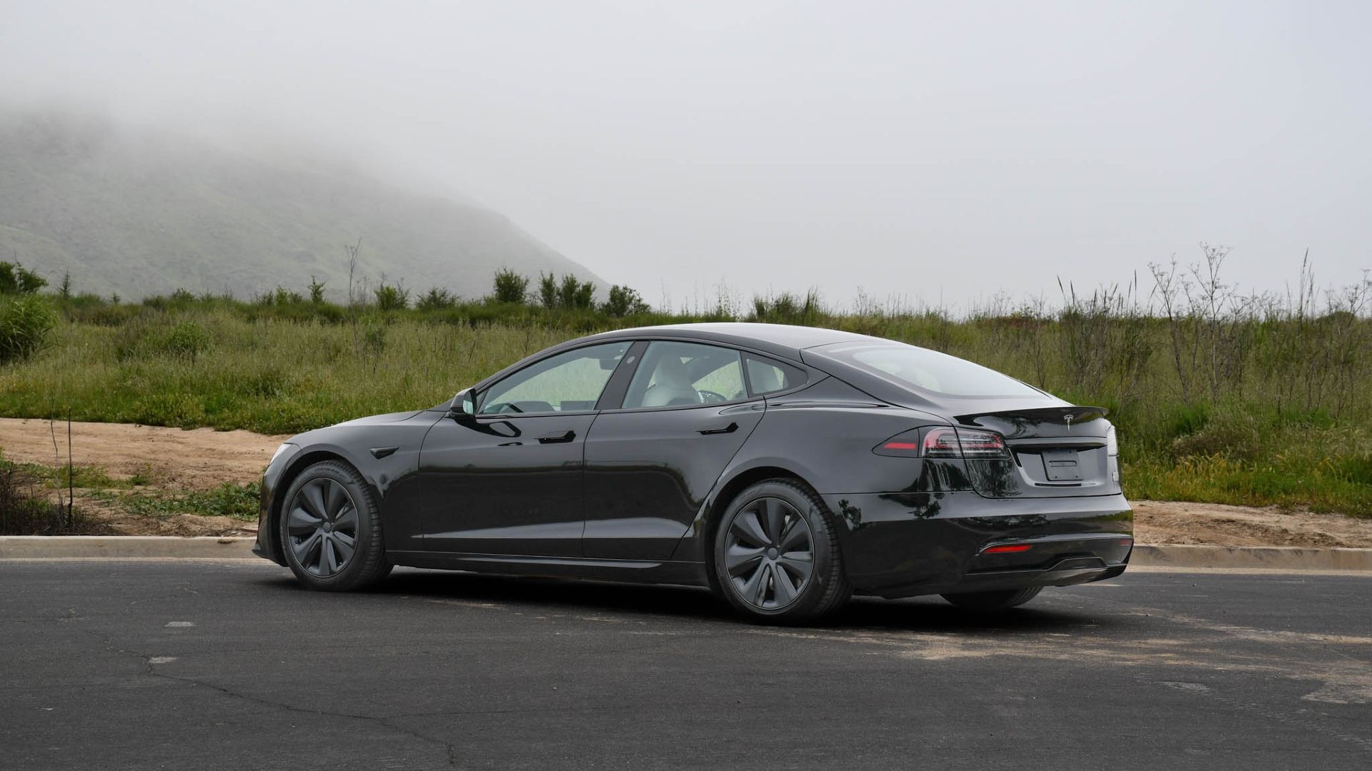 Rear-three quarters shot of a black 2022 Tesla Model S Plaid 