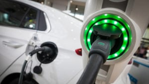 an electric vehicle (EV) at a charging station representing EV stocks