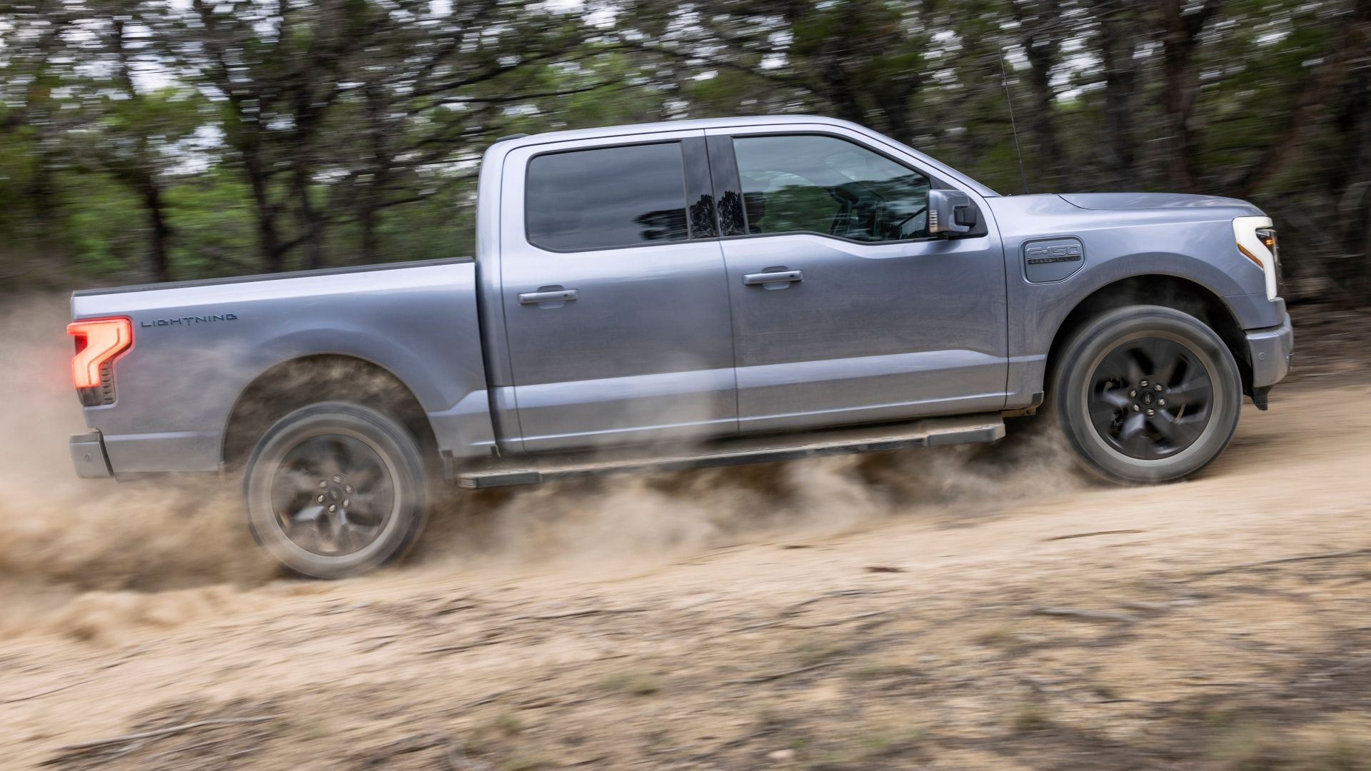 F150 Lightning Lariat driving on dirt