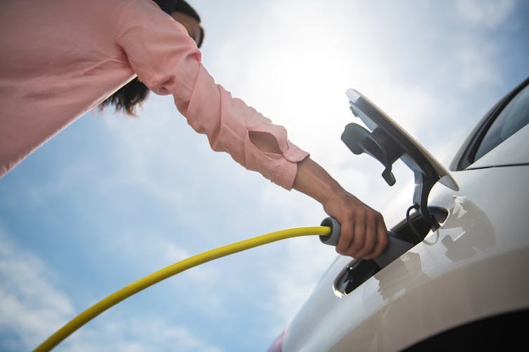 woman charging EV