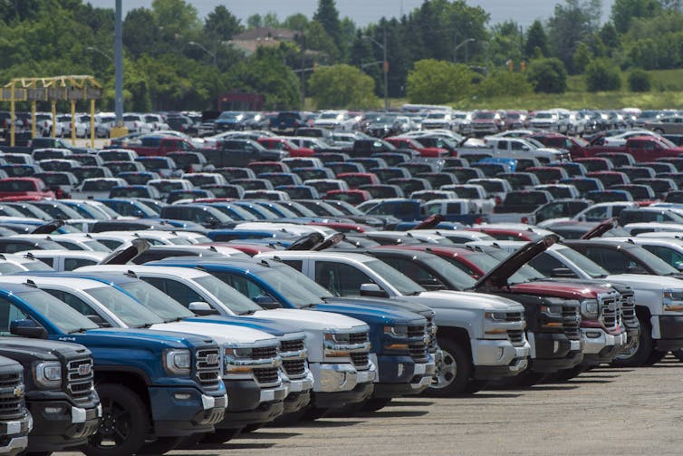 Vehicles are seen in a parking lot.