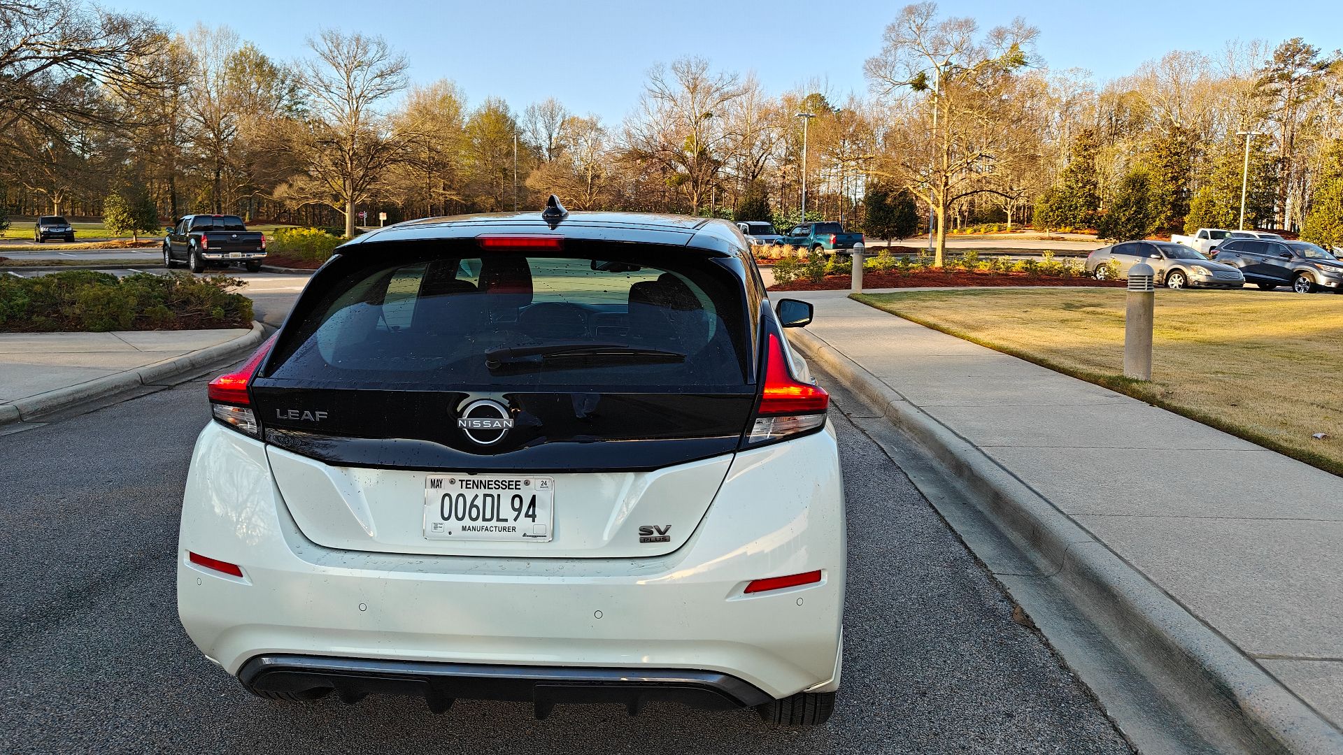 White 2024 Nissan Leaf in autumn