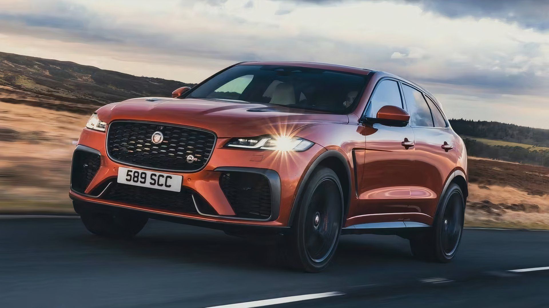 A Front 3/4 shot of a Jaguar F-Pace SVR cruising on asphalt