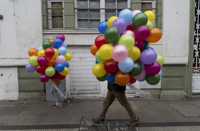 Protesters carry balloons to a march on International Workers' Day in Santiago, Chile, Wednesday, May 1, 2024. (AP Photo/Matias Basualdo)