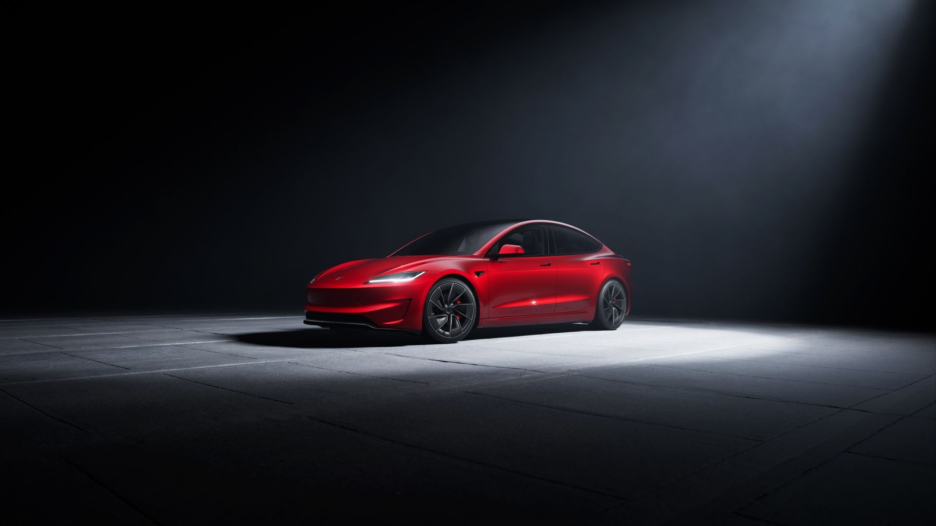 Front three-quarters shot of a red 2024 Tesla Model 3 Performance