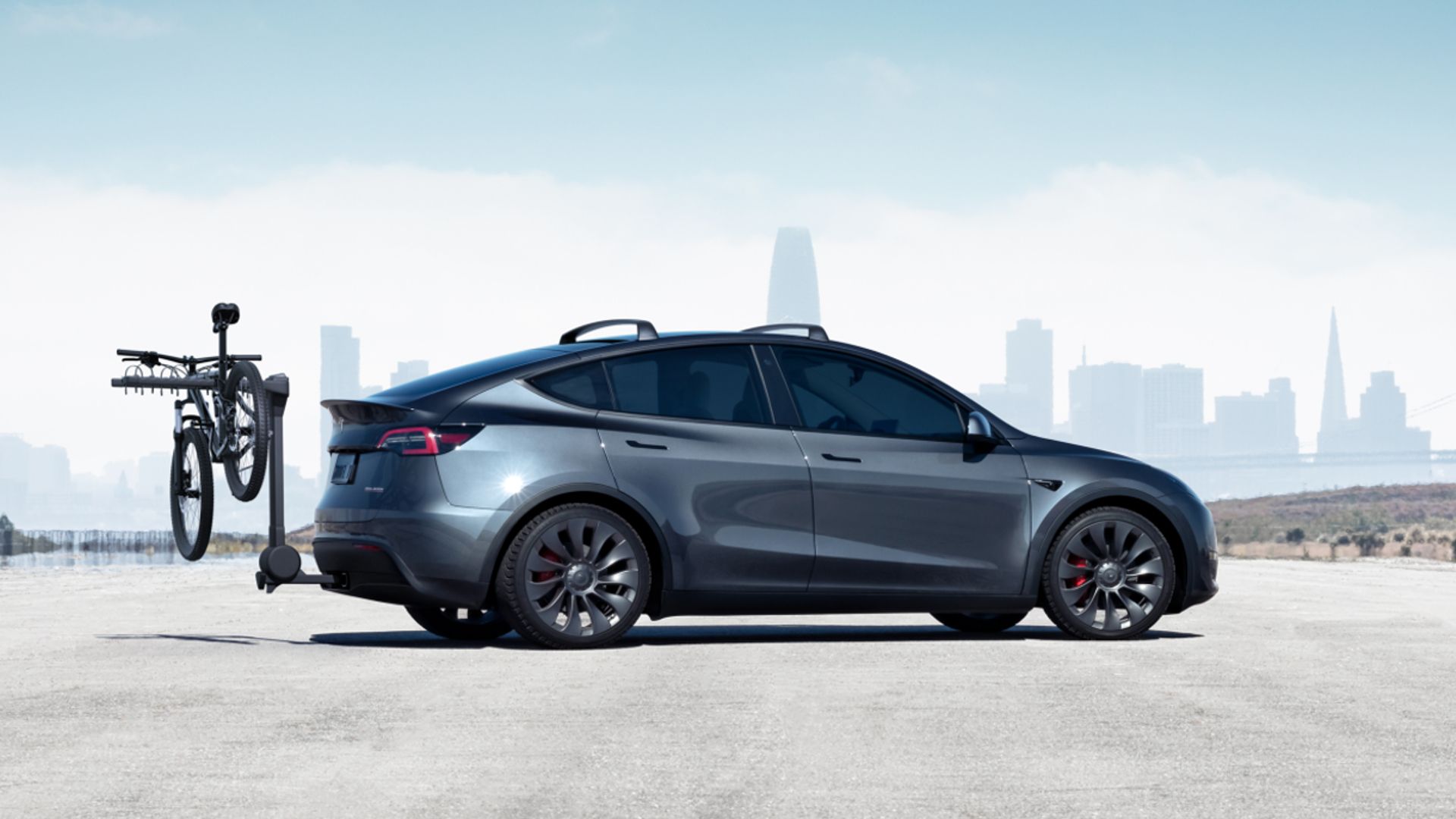 Side profile shot of a Tesla Model Y with a cycle hitched