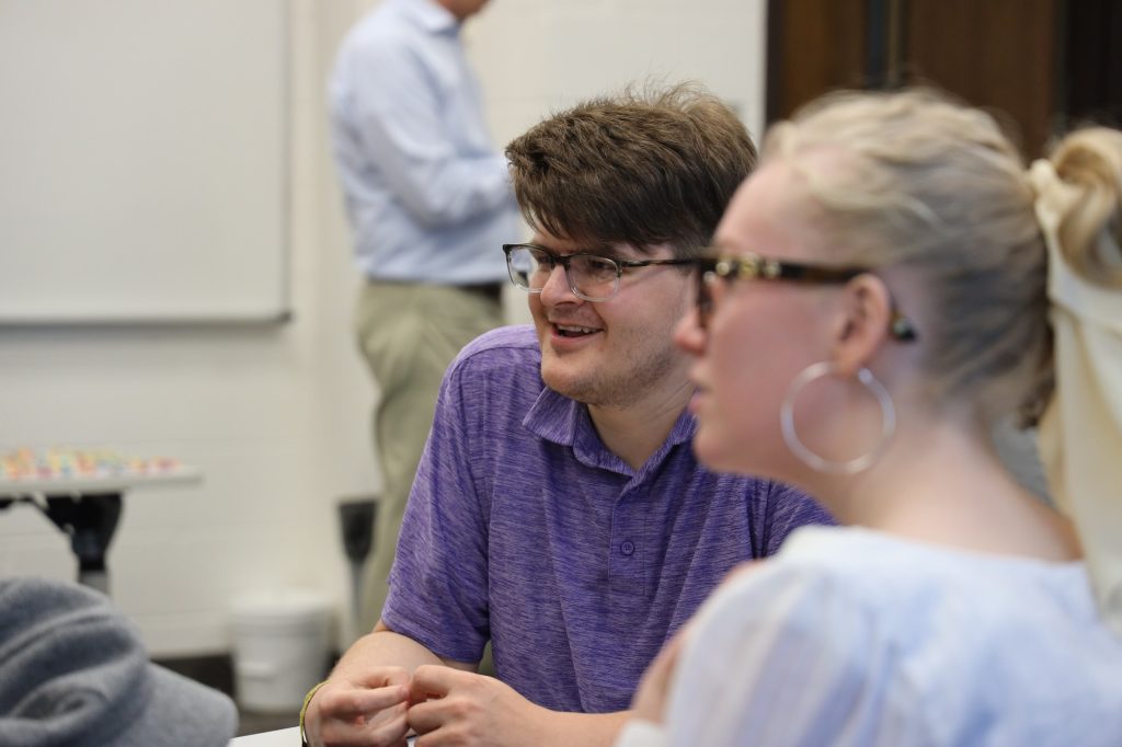 Students mingle before the meeting starts