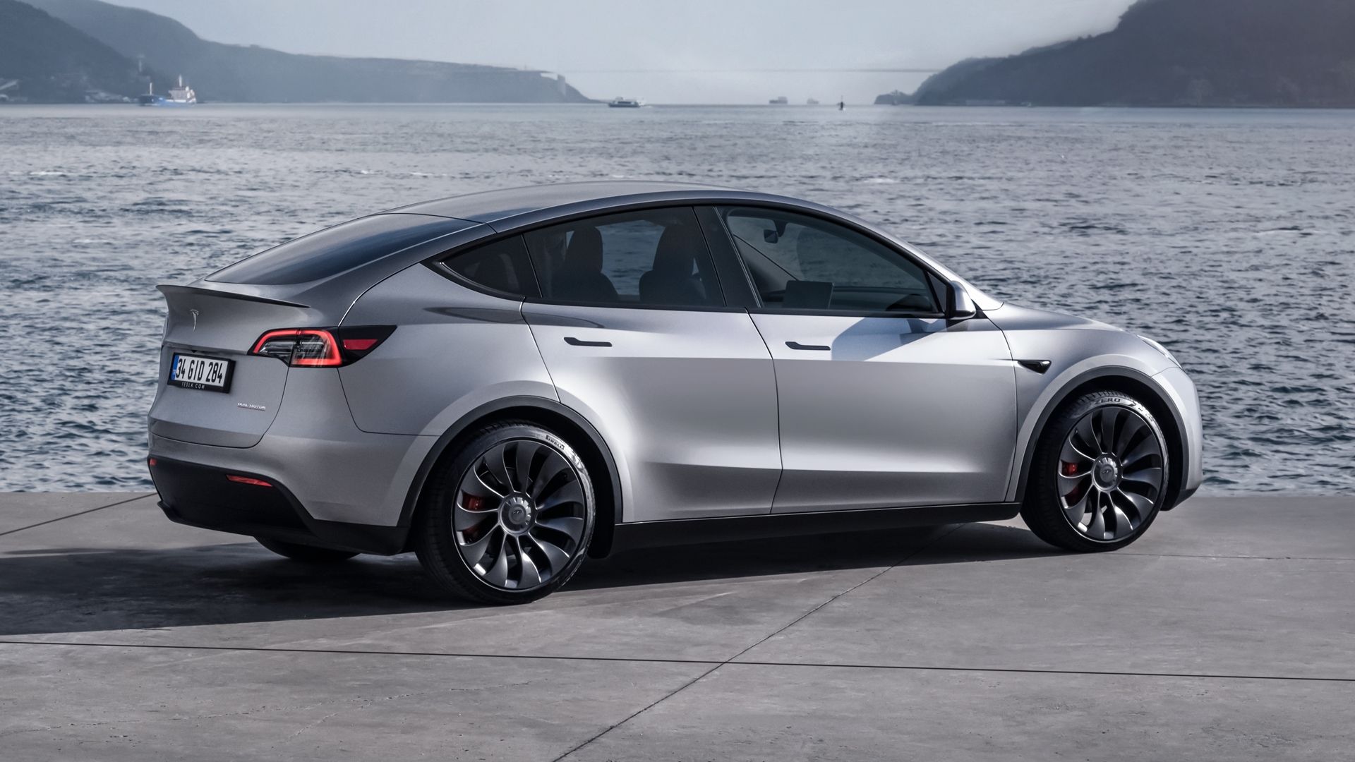 Silver Tesla Model Y rear-quarter