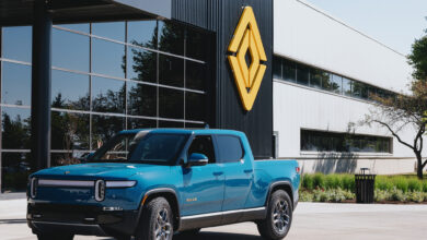 truck in front of building with rivian logo rivian.jpg