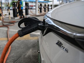 This picture taken on October 18, 2023 shows an electric vehicle being charged at Antuoshan charging station in Shenzhen, China's southern Guangdong province.