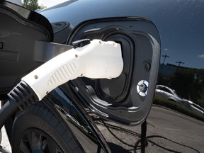 A Ford Mustang Mach E electric vehicle is charged at a dealership on June 05, 2024 in Chicago, Ill.