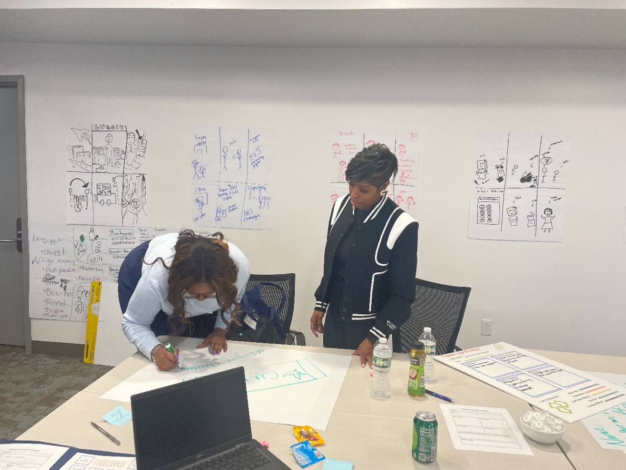 Students at the symposium work at a table together to brainstorm ideas.