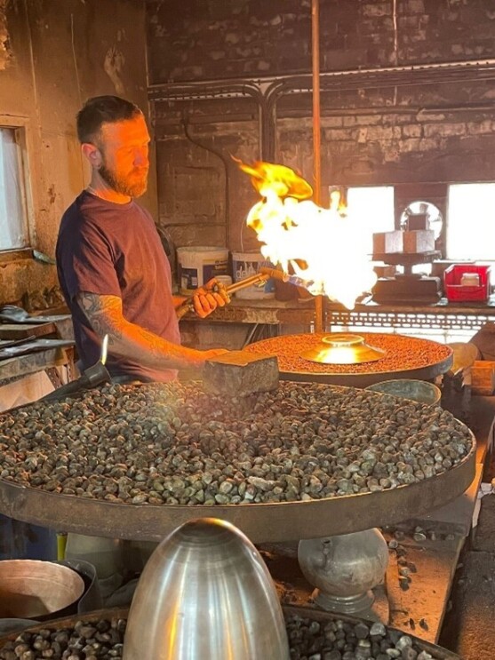 A silversmith creating the trophy in a workshop