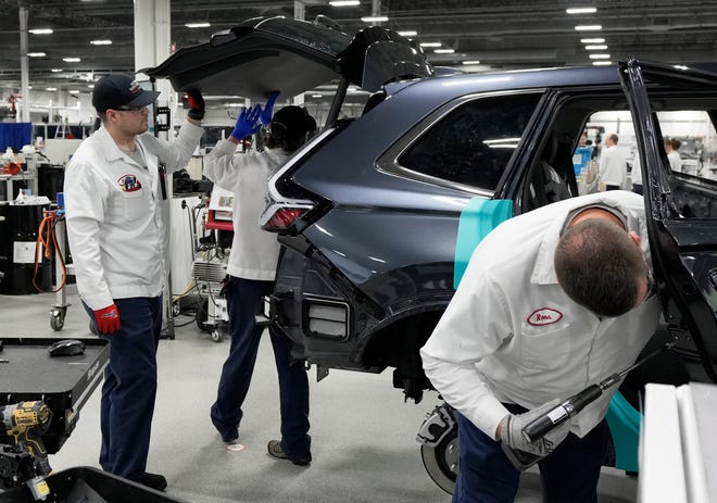 Honda technicians work on a CR-V fuel cell electric vehicle Wednesday at the Performance Manufacturing Center in Marysville. The vehicle, which will only be initially available in California, is part of the company's effort to have 100% zero emissions sales by 2040.