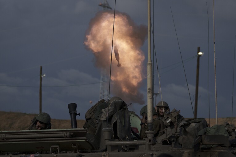 FILE - Israeli soldiers fire a mortar shell from southern Israel towards the Gaza Strip, in a position near the Israel-Gaza border , on Jan. 3, 2024. An AP analysis of Gaza Health Ministry data finds the proportion of Palestinian women and children being killed in the Israel-Hamas war appears to have declined sharply. Israel faces heavy international criticism over unprecedented levels of civilian casualties in Gaza. (AP Photo/Leo Correa, File)