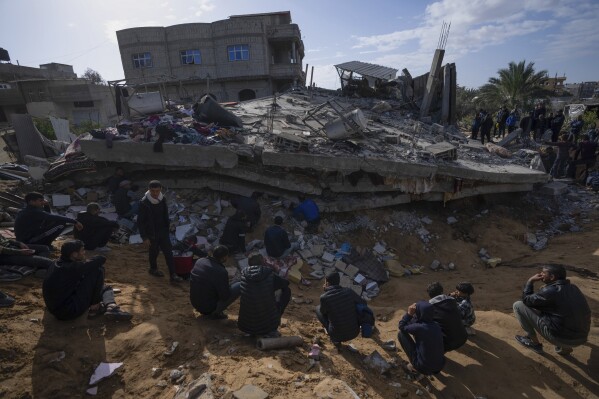 FILE - Palestinians search for bodies and survivors in the rubble of a residential building destroyed in an Israeli airstrike in Rafah, Gaza Strip, on March 4, 2024. An AP analysis of Gaza Health Ministry data finds the proportion of Palestinian women and children being killed in the Israel-Hamas war appears to have declined sharply. Israel faces heavy international criticism over unprecedented levels of civilian casualties in Gaza. (AP Photo/Fatima Shbair, File)