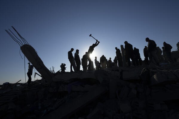 FILE - Palestinians search for bodies and survivors in the rubble of a house destroyed in an Israeli airstrike, in Rafah, southern Gaza Strip, on Jan. 7, 2024. An AP analysis of Gaza Health Ministry data finds the proportion of Palestinian women and children being killed in the Israel-Hamas war appears to have declined sharply. Israel faces heavy international criticism over unprecedented levels of civilian casualties in Gaza. (AP Photo/Fatima Shbair, File)