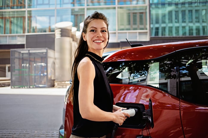 Driver charges their electric vehicle. 