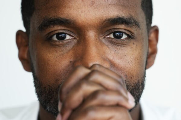 Adrian Perkins sits for a portrait in his office in Chicago, Thursday, June 13, 2024. When Perkins was running for reelection as mayor of Shreveport, La., in 2022, a satirical TV commercial, paid for by a rival political action committee, used artificial intelligence to depict Perkins as a high school student who had been called into the principal’s office. Although the ad was labeled as being created with "deep learning computer technology," he didn’t have enough money or campaign staff to counteract it, and thinks it was one of many reasons he lost the race. (AP Photo/Nam Y. Huh)