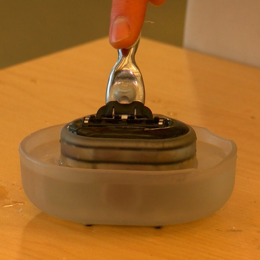 Andy Camp demonstrates the Razor Rinser in the IDEA Lab at the San Diego Central Library. The $30 invention is designed to clean disposable razors with less water and less need to bang them in the sink.