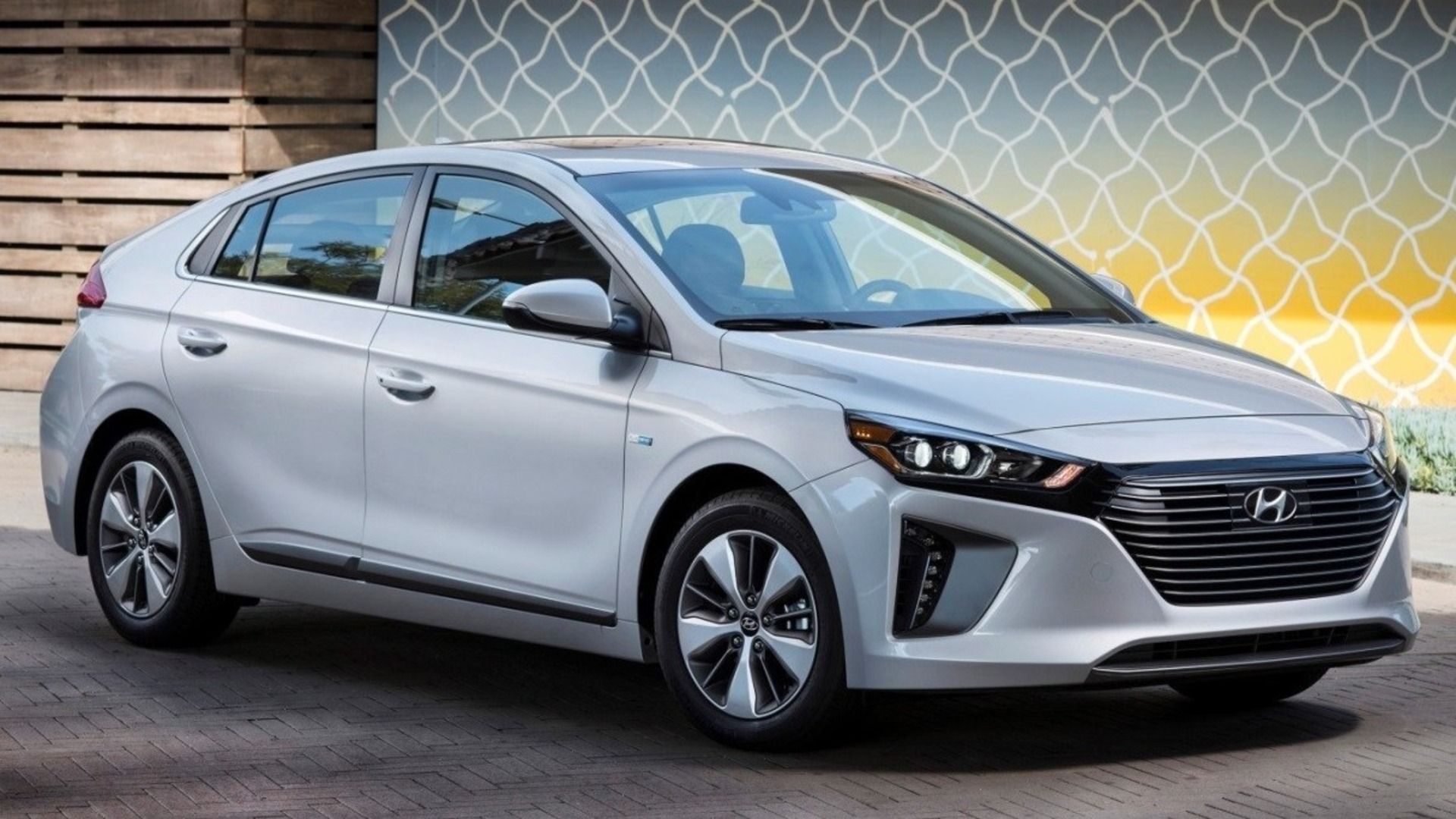 2018 Hyundai Ioniq in silver parked in front of a yellow and white mural.