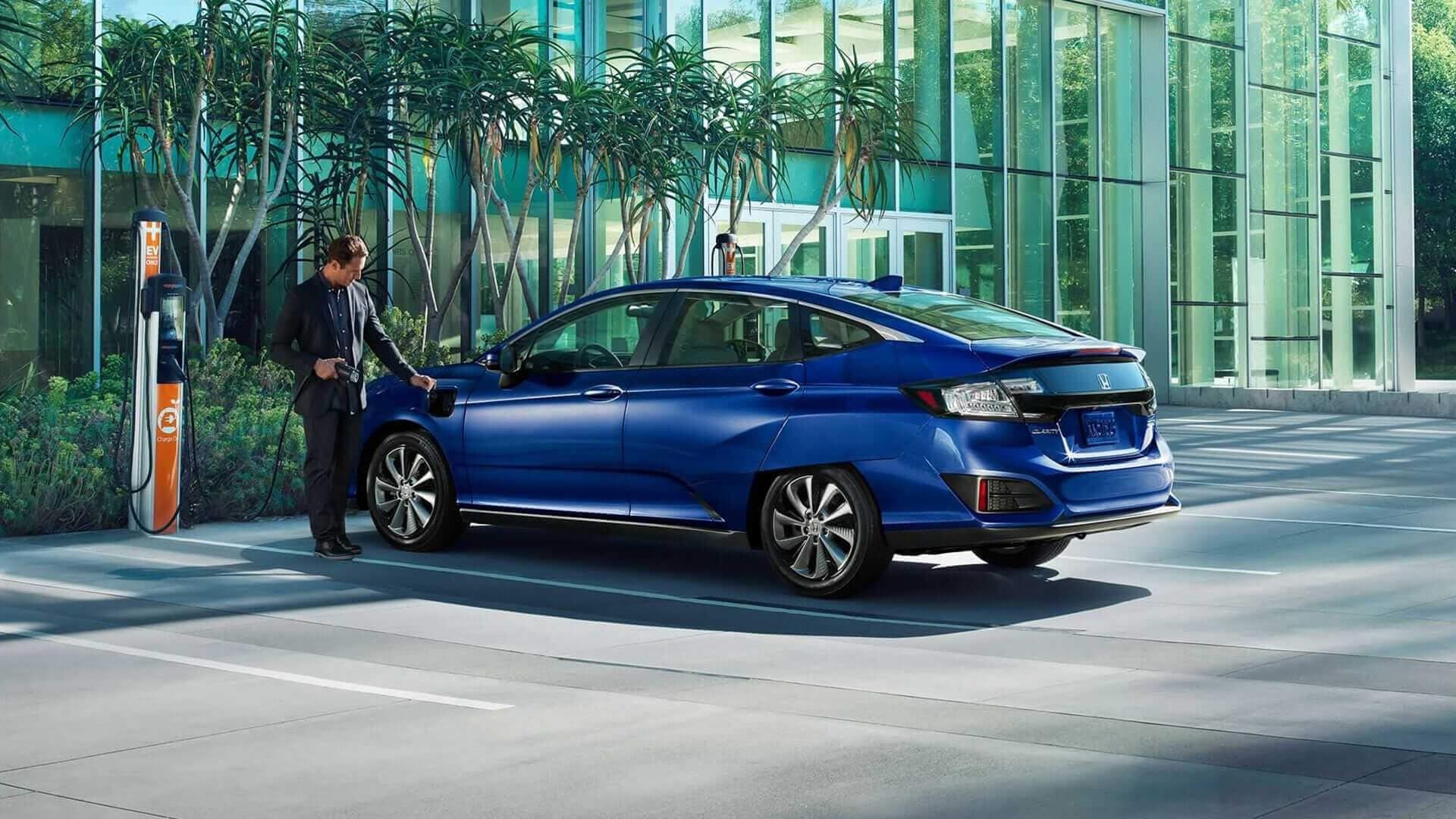 Blue 2019 Honda Clarity Electric being plugged in to charge