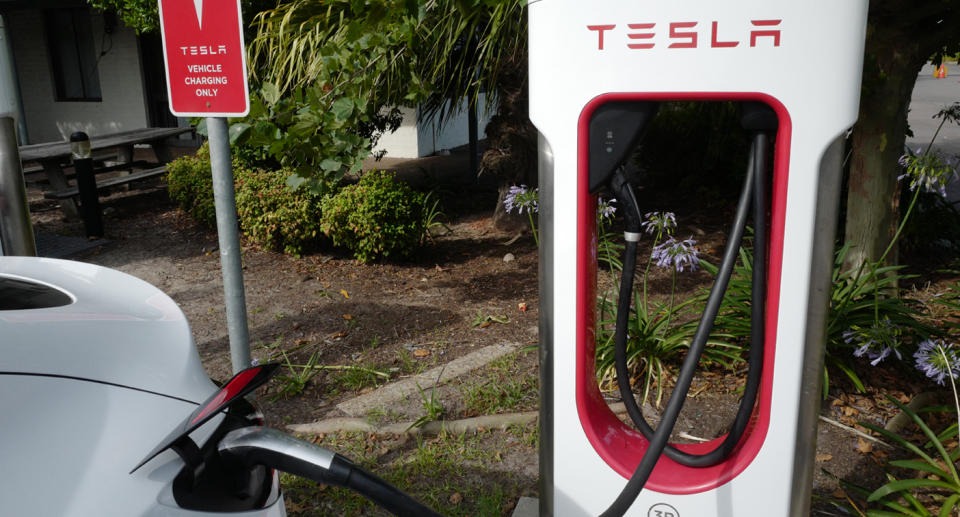 Tesla charger plugged into an EV.