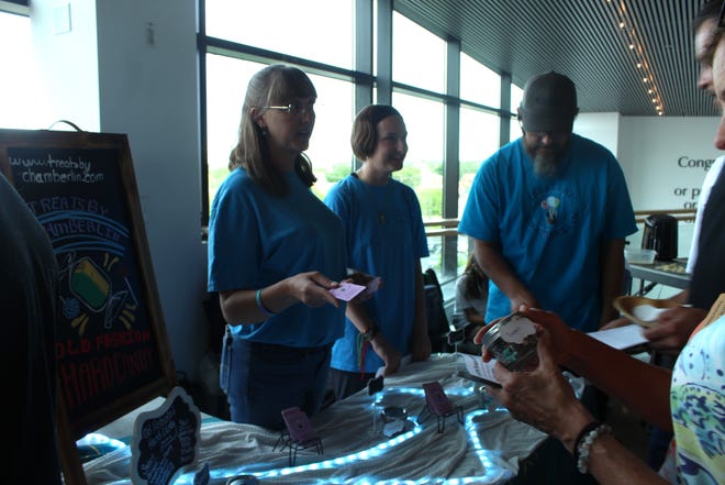 Jenn Chamberlin, left, helps a customer during Pueblo Food Project's Snack and Tell event at Rawlings Library on Tuesday, June 4, 2024.