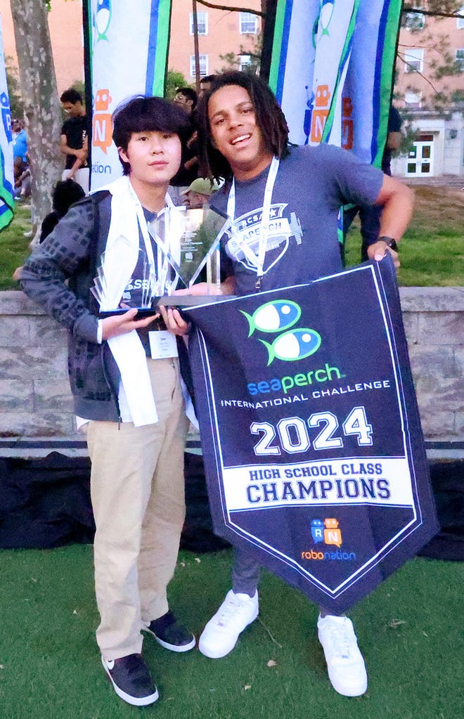 River City Science Academy Mandarin's Team Aquarius members Sam Pham, left, and Justin Duke display their first-place high school award at the 2024 International SeaPerch Challenge, an invitation-only underwater robot competition for students.