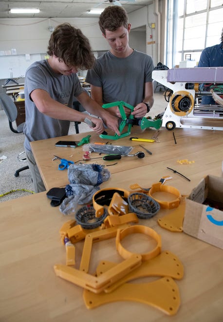 Catholic High School Robotics Team members Caleb Bobe and Ace London make final repairs and adjustments to an underwater submersible on Friday, June 14, 2024. The Catholic Robotic Club is preparing to travel to Tennessee for the MATE ROV world championship robotics competition.