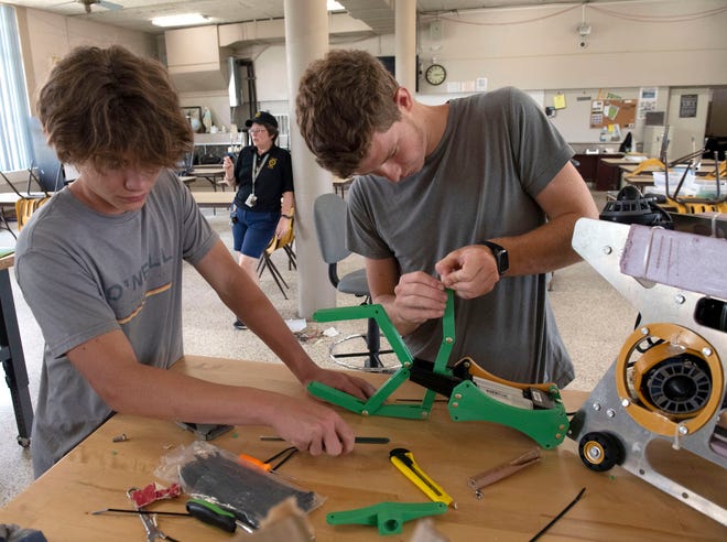 Catholic High School Robotics Team members Caleb Bobe and Ace London make final repairs and adjustments to an underwater submersible on Friday, June 14, 2024. The Catholic Robotic Club is preparing to travel to Tennessee for the MATE ROV world championship robotics competition.